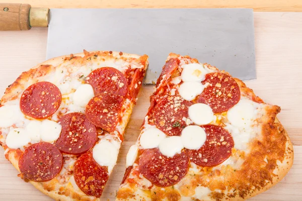 Pepperoni Pizza Cut with Cleaver — Stock Photo, Image