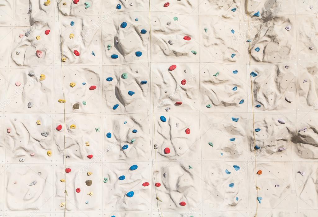 Colorful Foot And Hand Holds On Rock Climbing Wall Stock