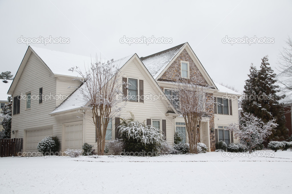 Siding and Stone House in Snow