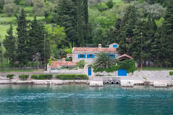 Stone Building with Blue Shutters on Shore — Stock Photo, Image