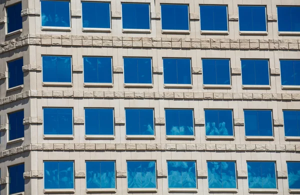 Синій квадрат windows у кам'яній будівлі — стокове фото