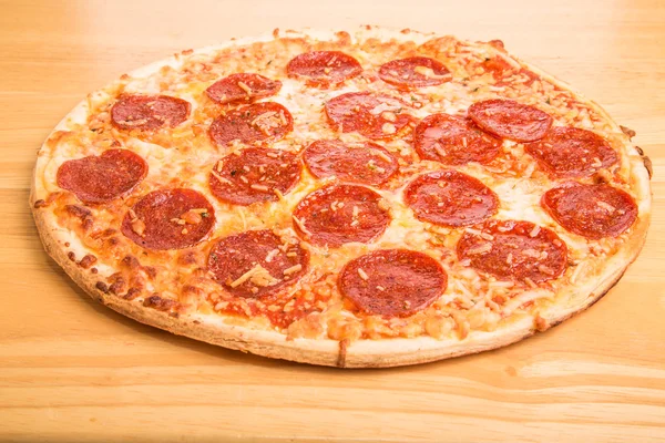 Whole Pepperoni Pizza on Wood Cutting Board — Stock Photo, Image