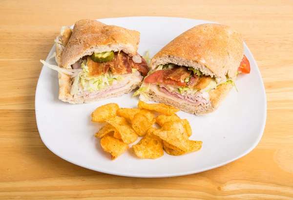 Sub Sandwich on Plate with Bacon and Potato Chips — Stock Photo, Image