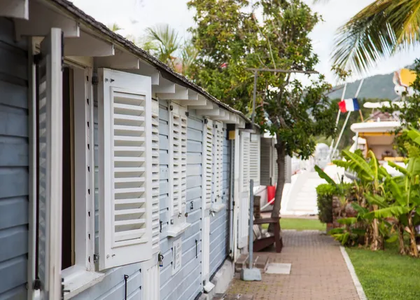 White Shutters on Grey Building with French Flag in Background — Stock Photo, Image