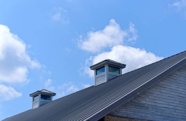 Two Wood Dormers on Metal Roof