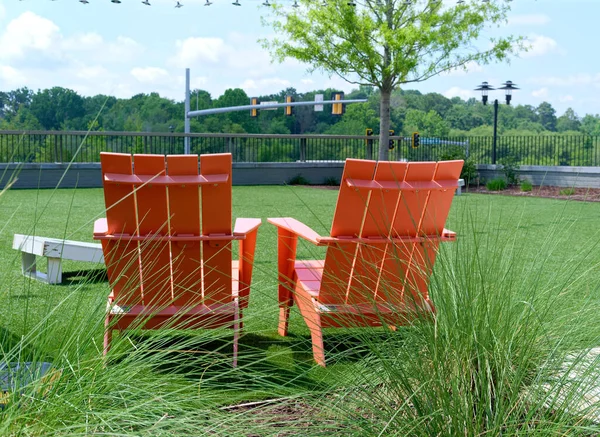 Orange Adirondack Chairs in Park