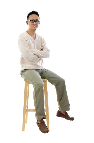 Full body Asian man sitting on a chair — Stock Photo, Image