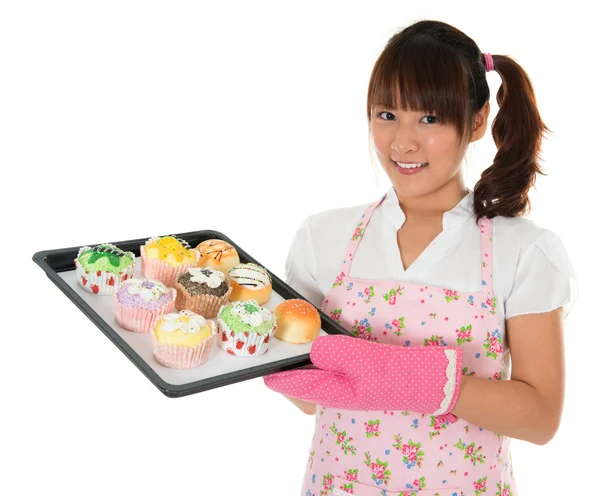 Young Asian girl baking bread and cupcakes — Stock Photo, Image