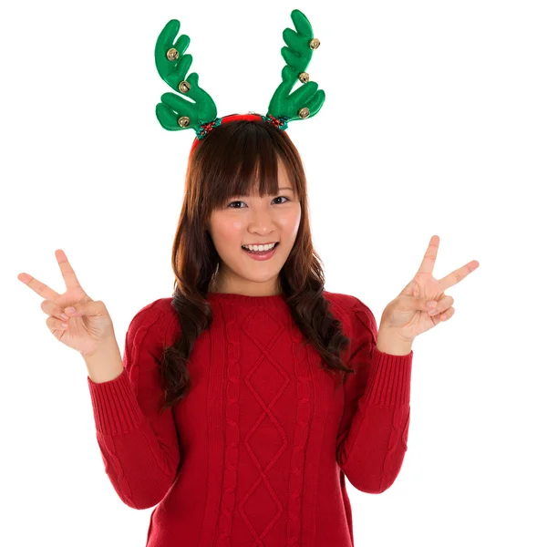 Asian Christmas girl showing victory sign. — Stock Photo, Image