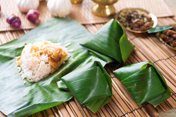 Nasi lemak wrapped with banana leaf. — Stock Photo, Image