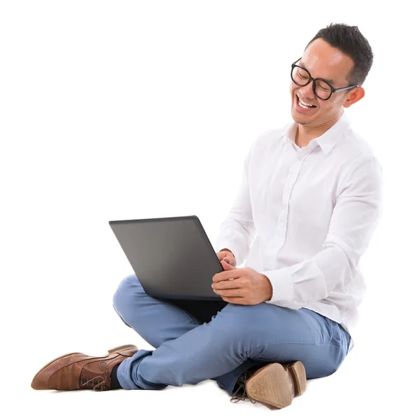 Excited Asian male using laptop — Stock Photo, Image