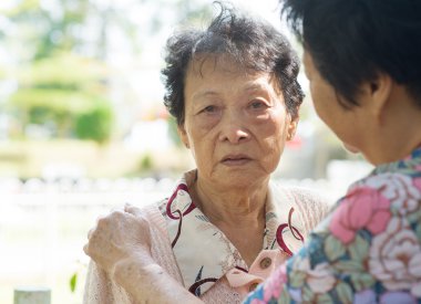 Mature woman consoling her crying old mother