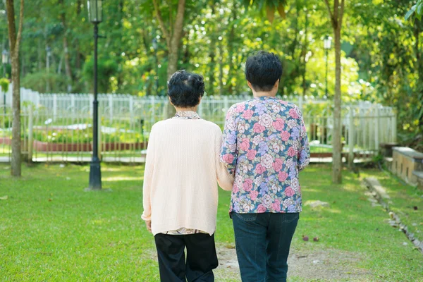 Rear view Asian old mother and senior daughter walking at outdoo — Stock Photo, Image