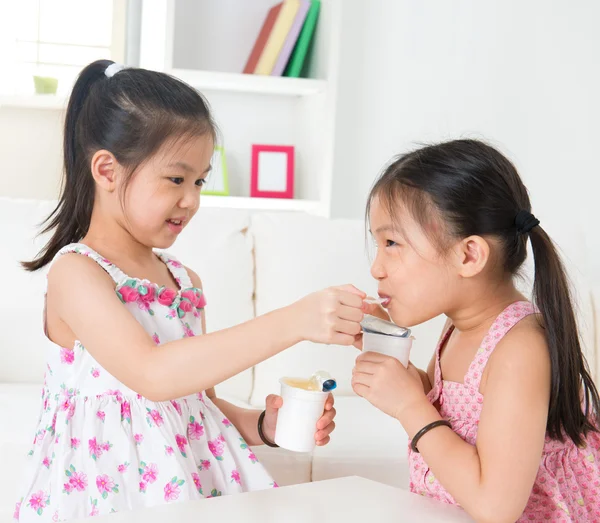 Дети едят йогурт — стоковое фото