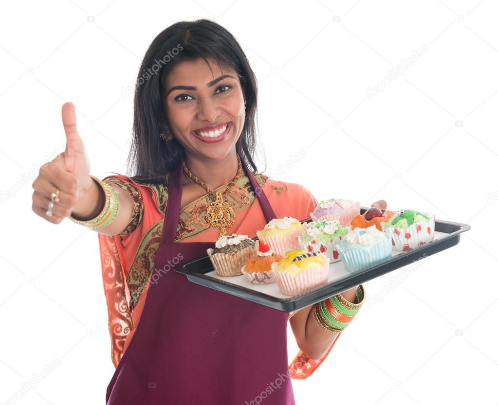 Thumb up Indian woman baking cupcakes
