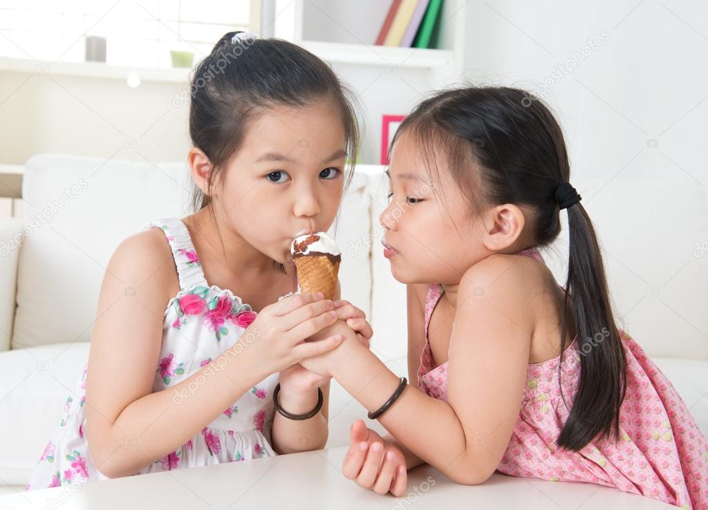 Asian kids eating ice cream cone