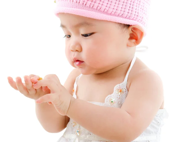 Aziatische baby meisje eten snack Stockafbeelding