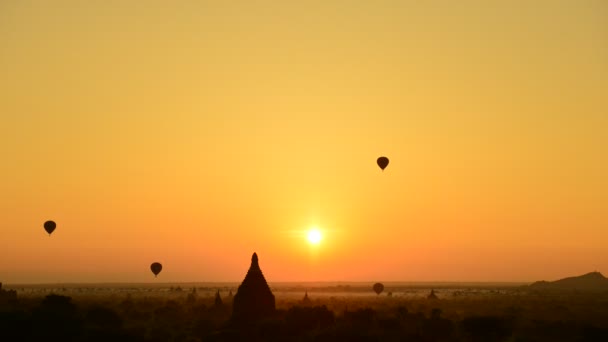 Hot air balloon and sunrise panorama view over temples of Bagan in Myanmar — Stock Video
