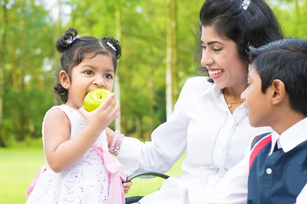 Indian girl eating apple — Stock Photo, Image