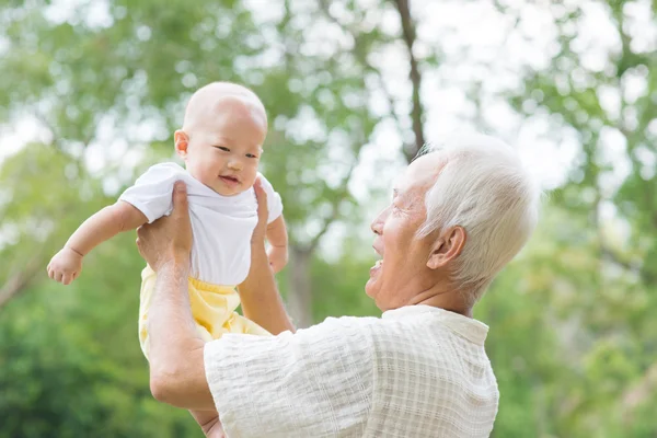Asian grandfather carrying grandson — Stock Photo, Image