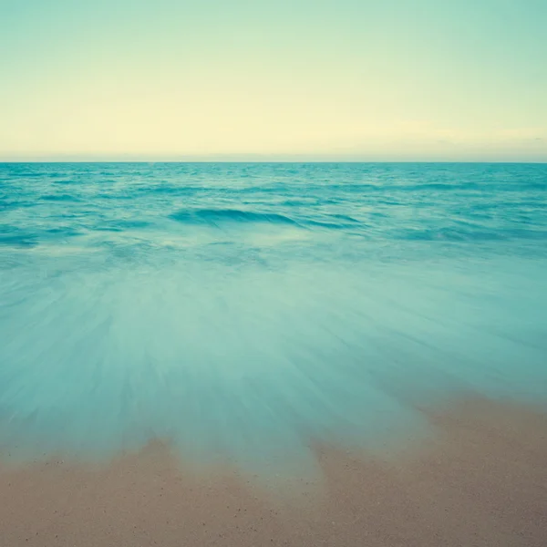 Vintage beach scene in sunset — Stock Photo, Image