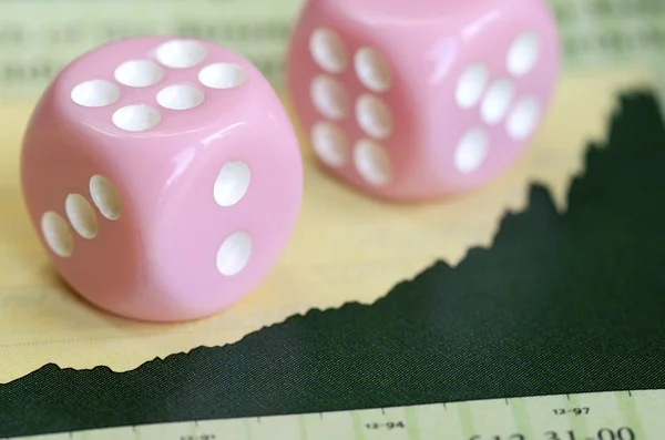 Two dices on a stock market graph concept of investment and finance — Stock Photo, Image