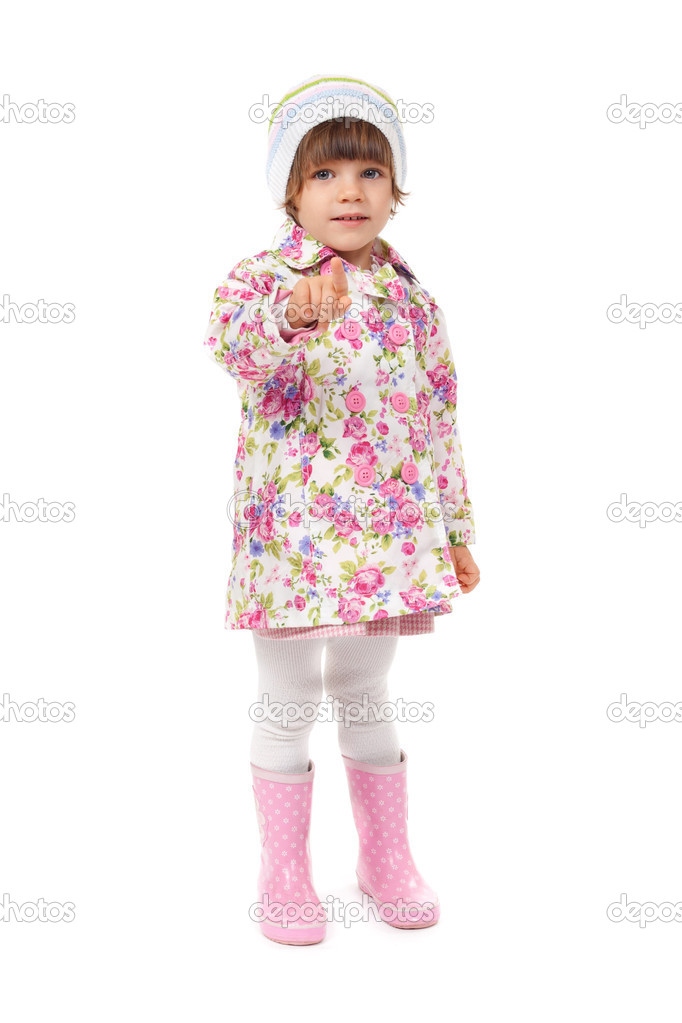 Little girl in boots and a jacket shows finger