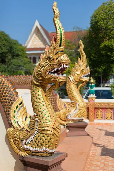 Thai golden dragon guards the entrance to the temple Stock Photo