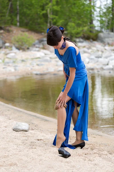 Beautiful girl in a blue dress stockings strips — Stock Photo, Image