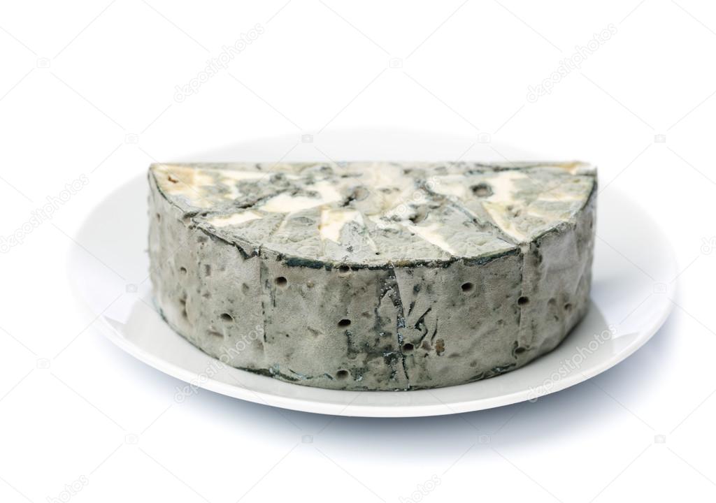 Cheese with black mold on the plate.