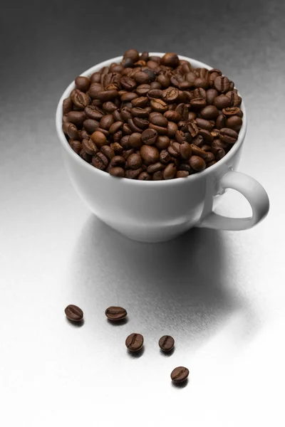 Cup of coffee, full of beans. — Stock Photo, Image