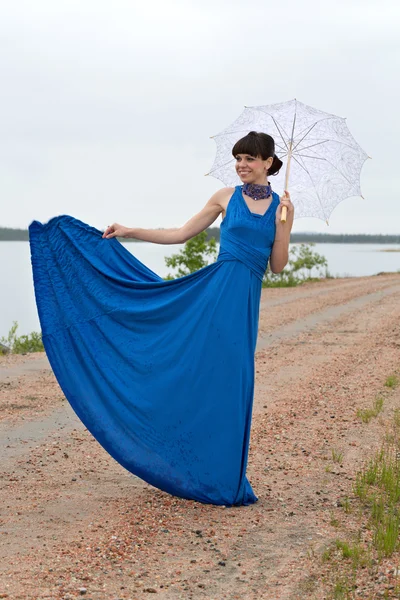 Smiling girl with an umbrella — Stock Photo, Image