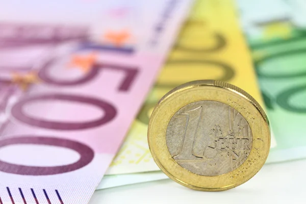 Euro coin against euro notes. — Stock Photo, Image