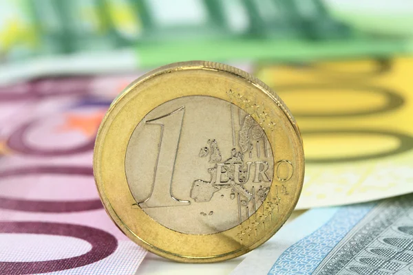 Euro coin against euro notes. — Stock Photo, Image