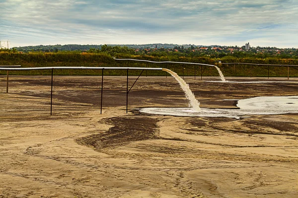 Toxic water stems from the pipe polluting the lake — Stock Photo, Image