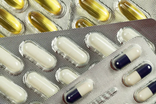 Capsules and pills packed — Stock Photo, Image