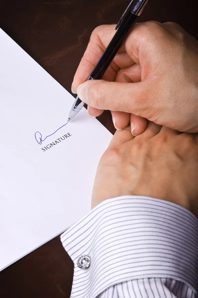 Human hand with pen signing a document — Stock Photo, Image