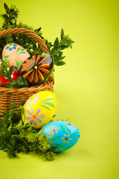 Beautiful decorative easter eggs in a basket — Stock Photo, Image