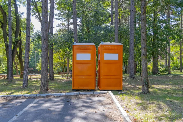 Two Orange Portable Toilet Cabins City Park — Stock Photo, Image