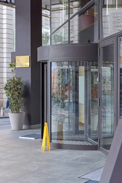 Automated Revolving Doors at Modern Building Entrance Side View