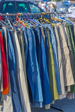 Blue Denim Jeans Pants Hanging at Railing Rack