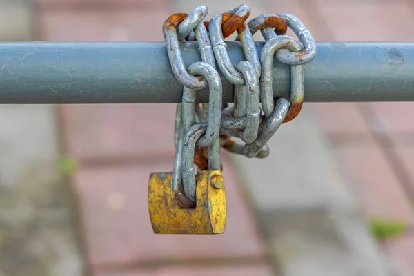 横フェンスポールの周り真鍮南京錠付きチェーン — ストック写真