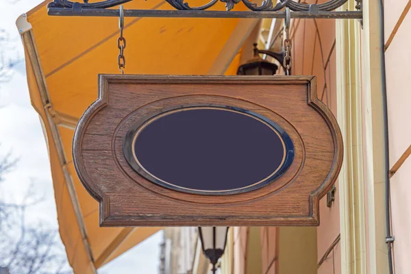 Black Oval Wooden Board Hanging Sign Chain Shop — стокове фото