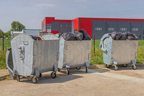 Three Metal Dumpster Bins Open Lid Overloaded Garbage Bags — Stock Fotó