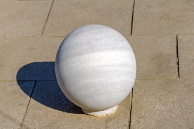 Very Large White Marble Ball at Street Pavement