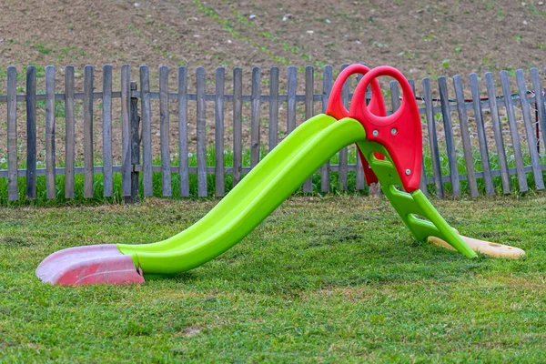 Plastic Green Slide Small Kids Grass Outdoor Playground Fun — Stock Photo, Image