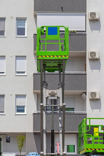 Scissor Lift Aerial Work Platform at Building Exterior