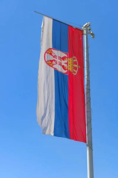 Very Large Serbian Flag at Tall Pole Blue Sky