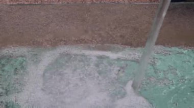 High Flow of Clean Water From Pipe in Pool