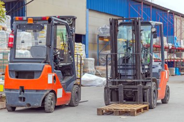 Two Forklift Machine Vehicles at Open Warehouse Storage Transport